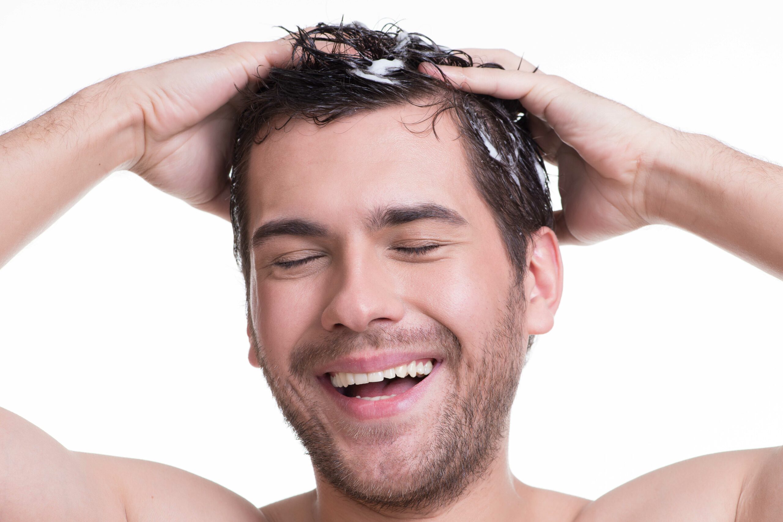 young-happy-smiling-man-washing-hair-with-closed-eyes-isolated-white